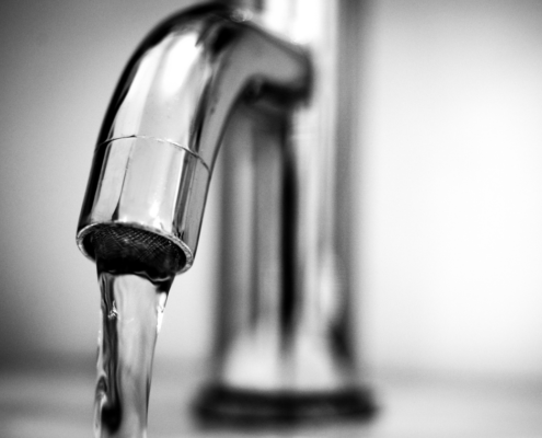 Running tap water, representing private well sample collection for water testing