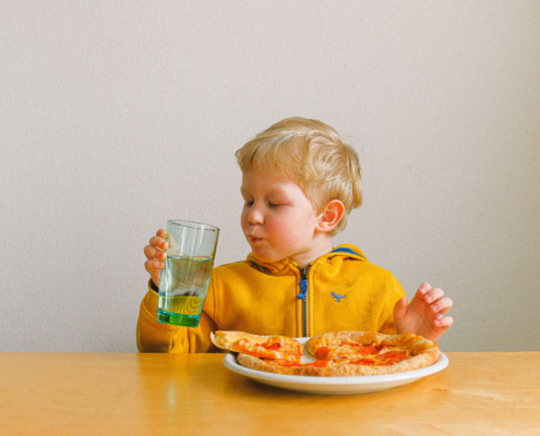 Young child drinking water highlighting the importance of lead-free water for child development